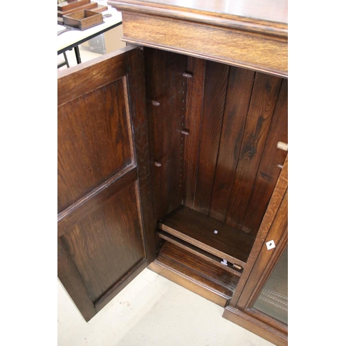 649 - Early 20th century Oak Breakfront Sideboard, the central glazed door opening to three adjustable she... 