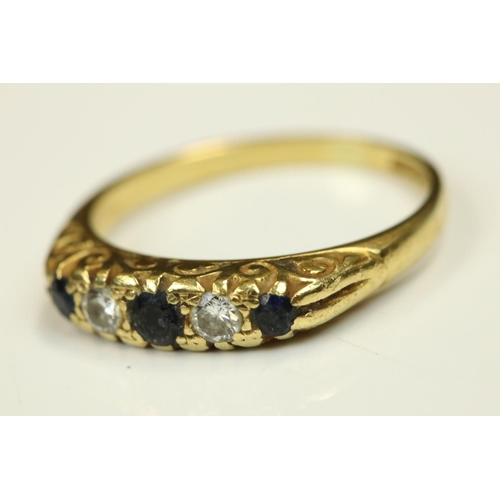 103 - Sapphire and diamond 18ct yellow gold five stone ring, small round mixed cut stones, claw set, scrol... 