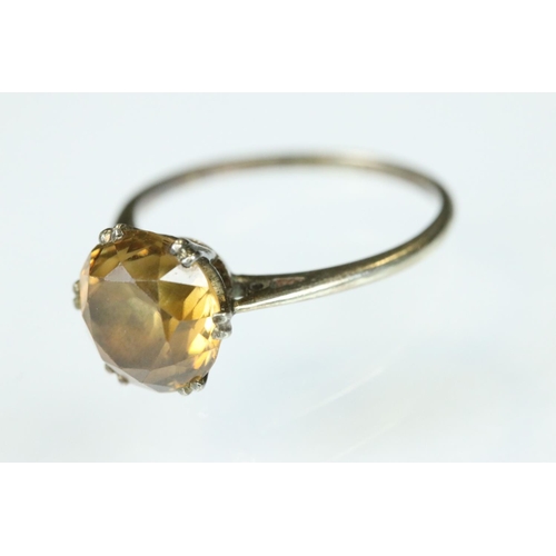 111 - Orange topaz white metal ring, the round mixed cut topaz diameter approx 8mm, claw set, tapered shou... 