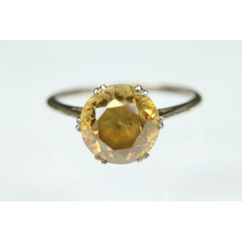 111 - Orange topaz white metal ring, the round mixed cut topaz diameter approx 8mm, claw set, tapered shou... 