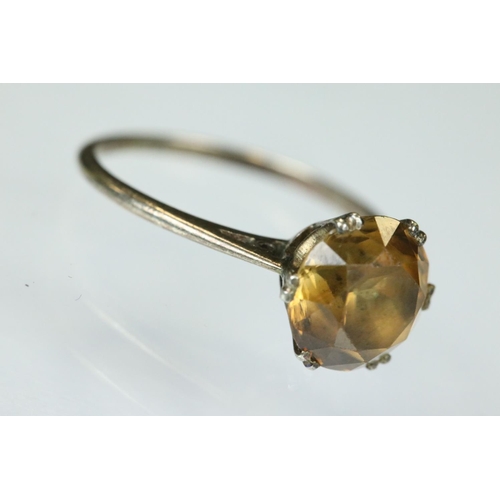 111 - Orange topaz white metal ring, the round mixed cut topaz diameter approx 8mm, claw set, tapered shou... 