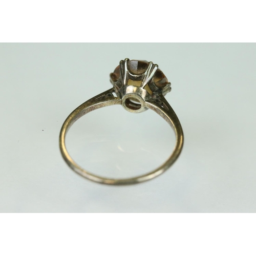 111 - Orange topaz white metal ring, the round mixed cut topaz diameter approx 8mm, claw set, tapered shou... 