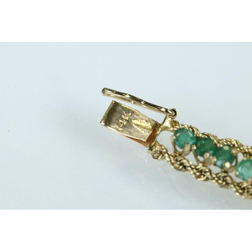 92 - Emerald 14ct yellow gold line bracelet, fifty-four small round mixed cut emeralds, claw set, rope tw... 