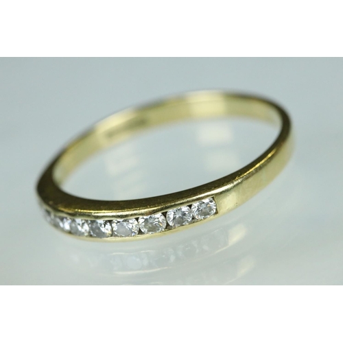 95 - Diamond 18ct yellow gold ring, nine small round brilliant cut diamonds, channel set, ring size Q