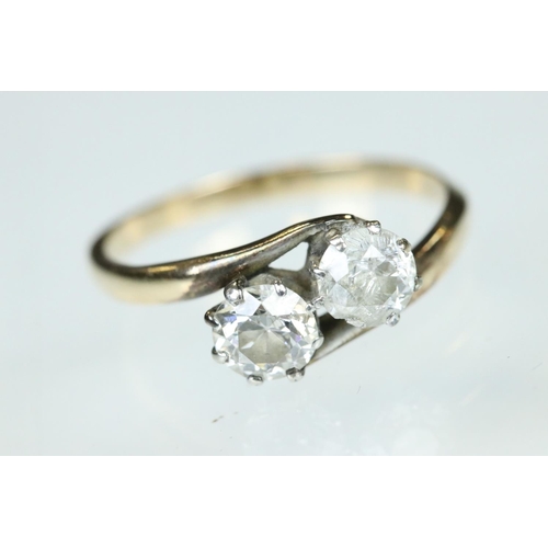 98 - Diamond two stone unmarked yellow and white gold set ring, two round brilliant cut diamonds, each we... 
