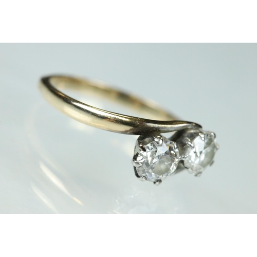 98 - Diamond two stone unmarked yellow and white gold set ring, two round brilliant cut diamonds, each we... 