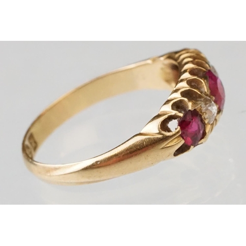 22 - Early 20th century ruby and diamond 18ct yellow gold ring, three graduated  round mixed cut rubies, ... 