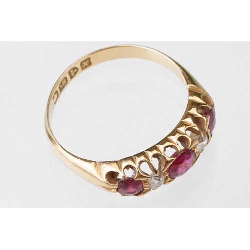 22 - Early 20th century ruby and diamond 18ct yellow gold ring, three graduated  round mixed cut rubies, ... 