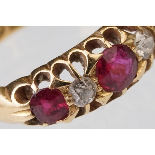 22 - Early 20th century ruby and diamond 18ct yellow gold ring, three graduated  round mixed cut rubies, ... 