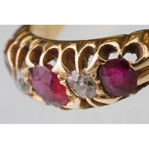 22 - Early 20th century ruby and diamond 18ct yellow gold ring, three graduated  round mixed cut rubies, ... 