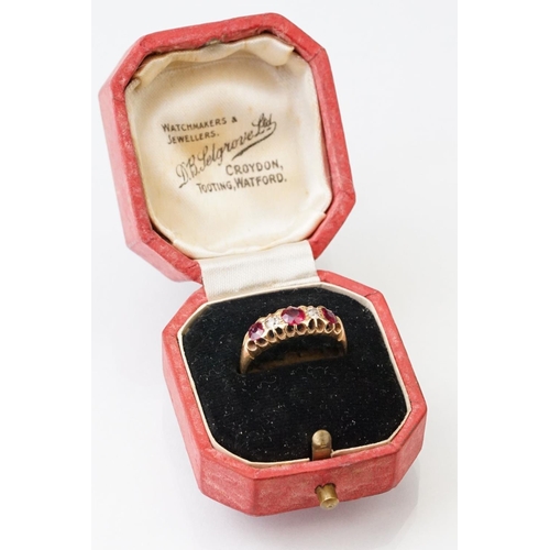 22 - Early 20th century ruby and diamond 18ct yellow gold ring, three graduated  round mixed cut rubies, ... 