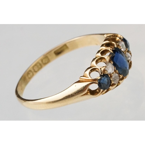 23 - Sapphire and diamond 18ct yellow gold boat head ring, the oval mixed cut principal sapphire measurin... 