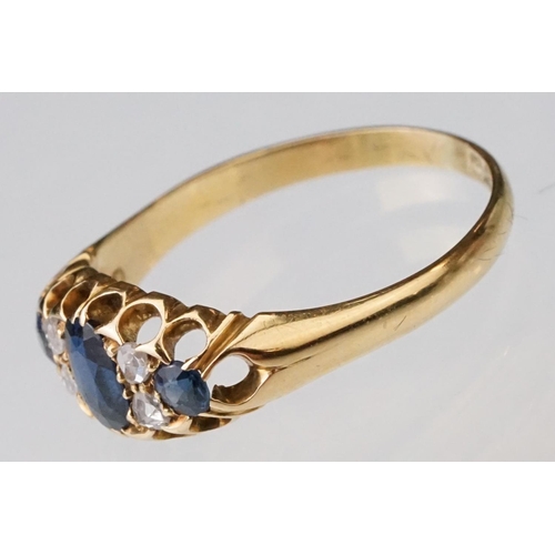 23 - Sapphire and diamond 18ct yellow gold boat head ring, the oval mixed cut principal sapphire measurin... 
