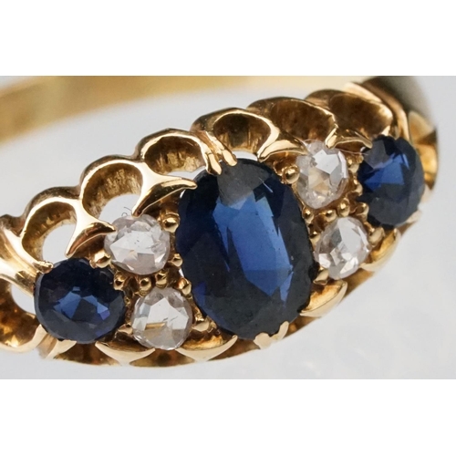 23 - Sapphire and diamond 18ct yellow gold boat head ring, the oval mixed cut principal sapphire measurin... 