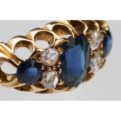 23 - Sapphire and diamond 18ct yellow gold boat head ring, the oval mixed cut principal sapphire measurin... 