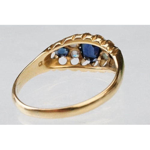 23 - Sapphire and diamond 18ct yellow gold boat head ring, the oval mixed cut principal sapphire measurin... 