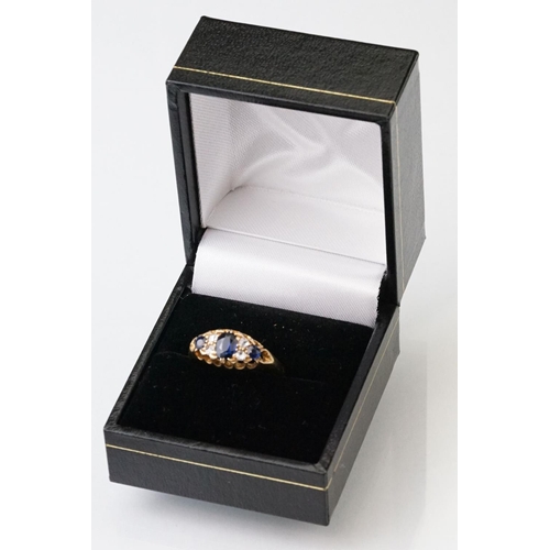 23 - Sapphire and diamond 18ct yellow gold boat head ring, the oval mixed cut principal sapphire measurin... 
