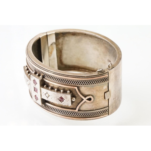 26 - Victorian paste and seed pearl parcel gilt silver hinged bangle, the raised central section set with... 