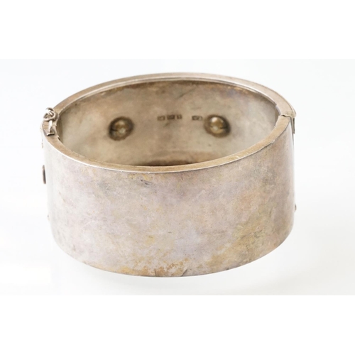 26 - Victorian paste and seed pearl parcel gilt silver hinged bangle, the raised central section set with... 