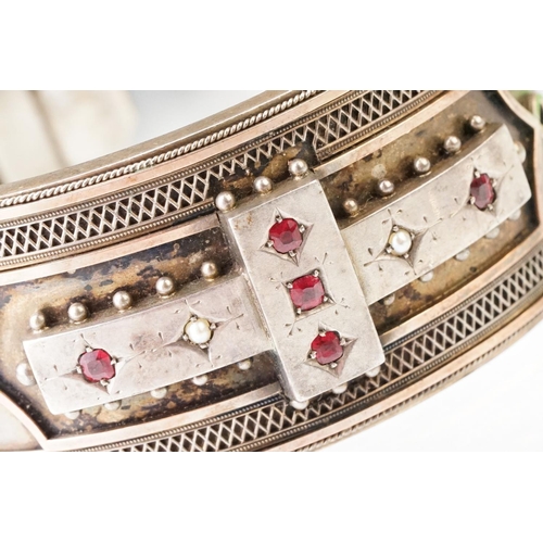 26 - Victorian paste and seed pearl parcel gilt silver hinged bangle, the raised central section set with... 