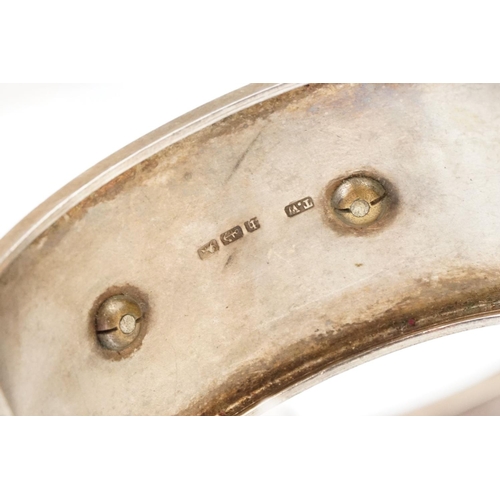 26 - Victorian paste and seed pearl parcel gilt silver hinged bangle, the raised central section set with... 