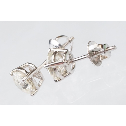 41 - Pair of diamond solitaire 14ct white gold stud earrings, modern round brilliant cut diamond, each we... 