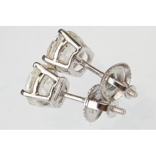 41 - Pair of diamond solitaire 14ct white gold stud earrings, modern round brilliant cut diamond, each we... 