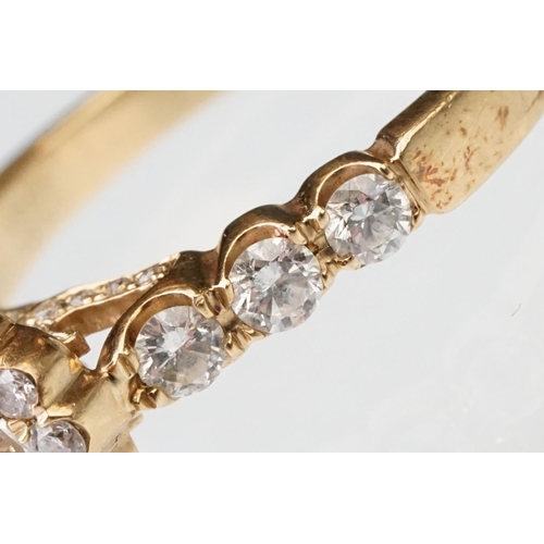 43 - Diamond halo yellow metal ring, the round mixed cut diamond measuring approx 5.6mm x 5.7mm x 4.7mm, ... 