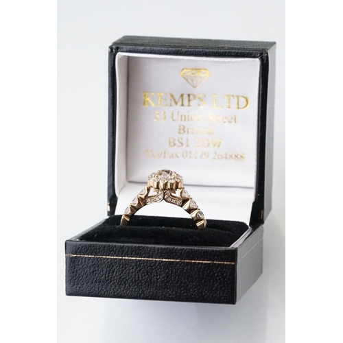 43 - Diamond halo yellow metal ring, the round mixed cut diamond measuring approx 5.6mm x 5.7mm x 4.7mm, ... 