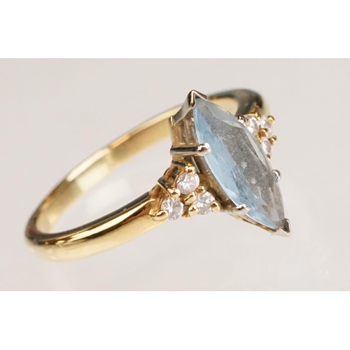 62 - Aquamarine and diamond 18ct yellow gold ring, the marquise cut aquamarine measuring approx 12.5mm x ... 