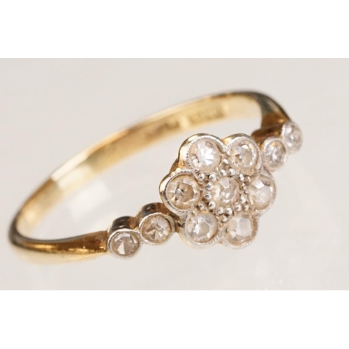 63 - Early 20th century diamond 18ct yellow gold and platinum set flower head ring, eleven small round ei... 