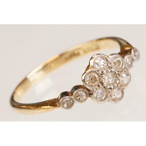 63 - Early 20th century diamond 18ct yellow gold and platinum set flower head ring, eleven small round ei... 