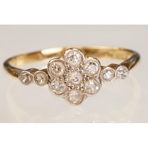 63 - Early 20th century diamond 18ct yellow gold and platinum set flower head ring, eleven small round ei... 