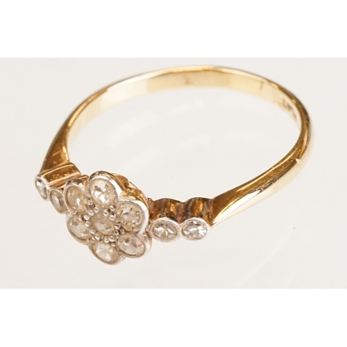 63 - Early 20th century diamond 18ct yellow gold and platinum set flower head ring, eleven small round ei... 