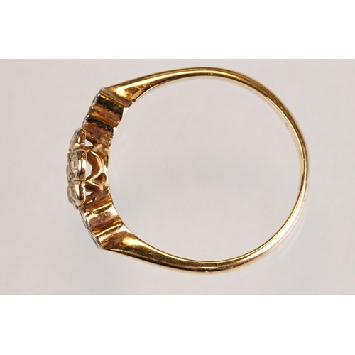 63 - Early 20th century diamond 18ct yellow gold and platinum set flower head ring, eleven small round ei... 