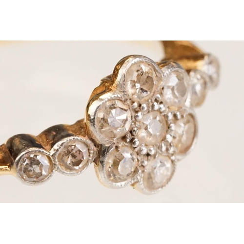 63 - Early 20th century diamond 18ct yellow gold and platinum set flower head ring, eleven small round ei... 