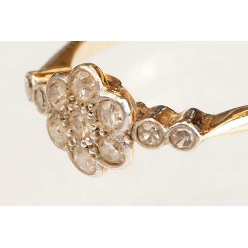 63 - Early 20th century diamond 18ct yellow gold and platinum set flower head ring, eleven small round ei... 