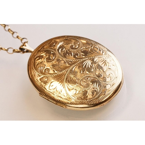 65 - Large yellow metal locket pendant necklace, the oval locket with engraved foliate decoration, dimens... 