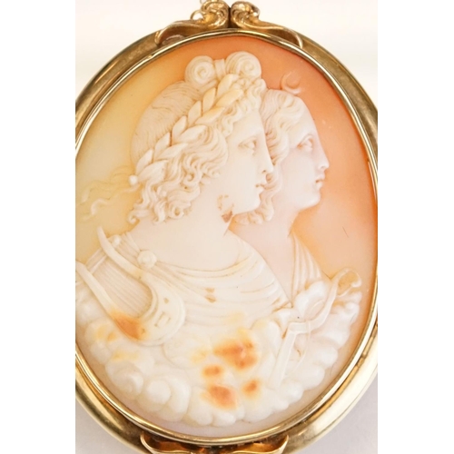 66 - 19th century shell cameo brooch depicting two female figures, yellow metal surround, hinged pin and ... 