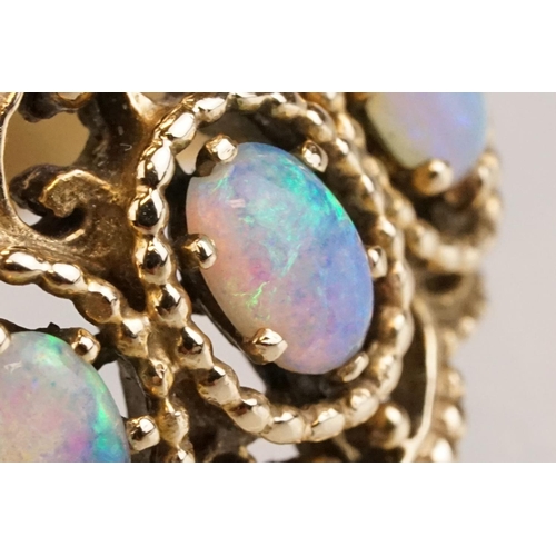 67 - Opal yellow metal three stone ring, three oval cabochon cut Ethiopian opals, displaying violet, blue... 