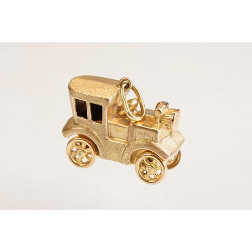 70 - Three 9ct yellow gold charms, an 8ct gold charm, a 14ct enamelled charm and a yellow metal charm (6)