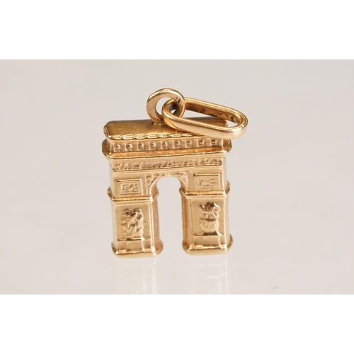 70 - Three 9ct yellow gold charms, an 8ct gold charm, a 14ct enamelled charm and a yellow metal charm (6)