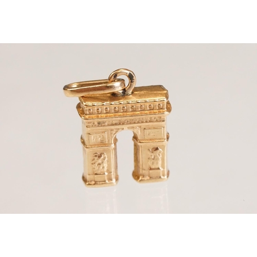 70 - Three 9ct yellow gold charms, an 8ct gold charm, a 14ct enamelled charm and a yellow metal charm (6)