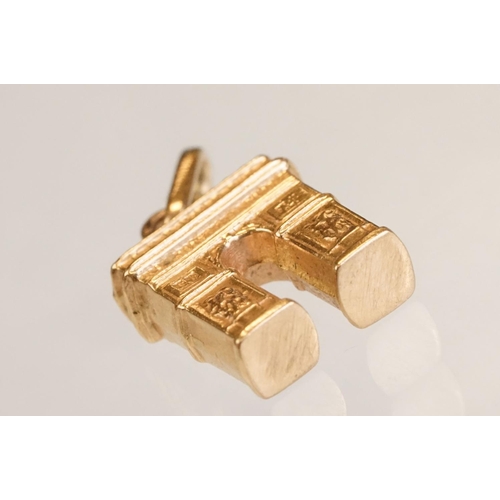 70 - Three 9ct yellow gold charms, an 8ct gold charm, a 14ct enamelled charm and a yellow metal charm (6)