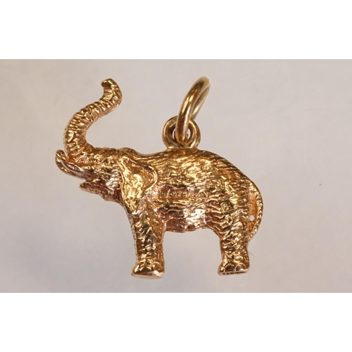 70 - Three 9ct yellow gold charms, an 8ct gold charm, a 14ct enamelled charm and a yellow metal charm (6)
