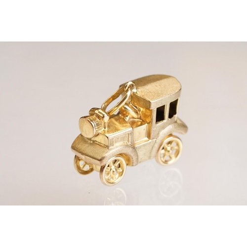 70 - Three 9ct yellow gold charms, an 8ct gold charm, a 14ct enamelled charm and a yellow metal charm (6)