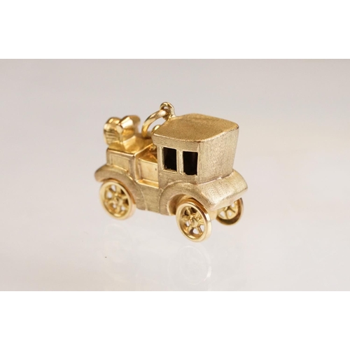 70 - Three 9ct yellow gold charms, an 8ct gold charm, a 14ct enamelled charm and a yellow metal charm (6)