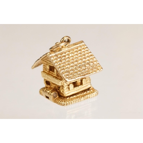 70 - Three 9ct yellow gold charms, an 8ct gold charm, a 14ct enamelled charm and a yellow metal charm (6)