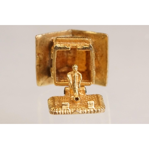 70 - Three 9ct yellow gold charms, an 8ct gold charm, a 14ct enamelled charm and a yellow metal charm (6)