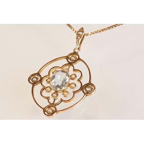 71 - Early 20th century aquamarine and seed pearl 9ct yellow gold pendant, the openwork design with oval ... 